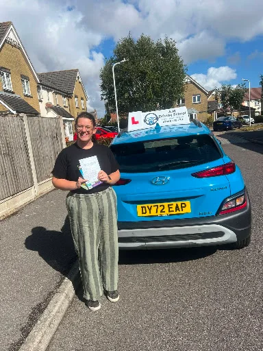 Emma celebrating driving test pass outside test centre
